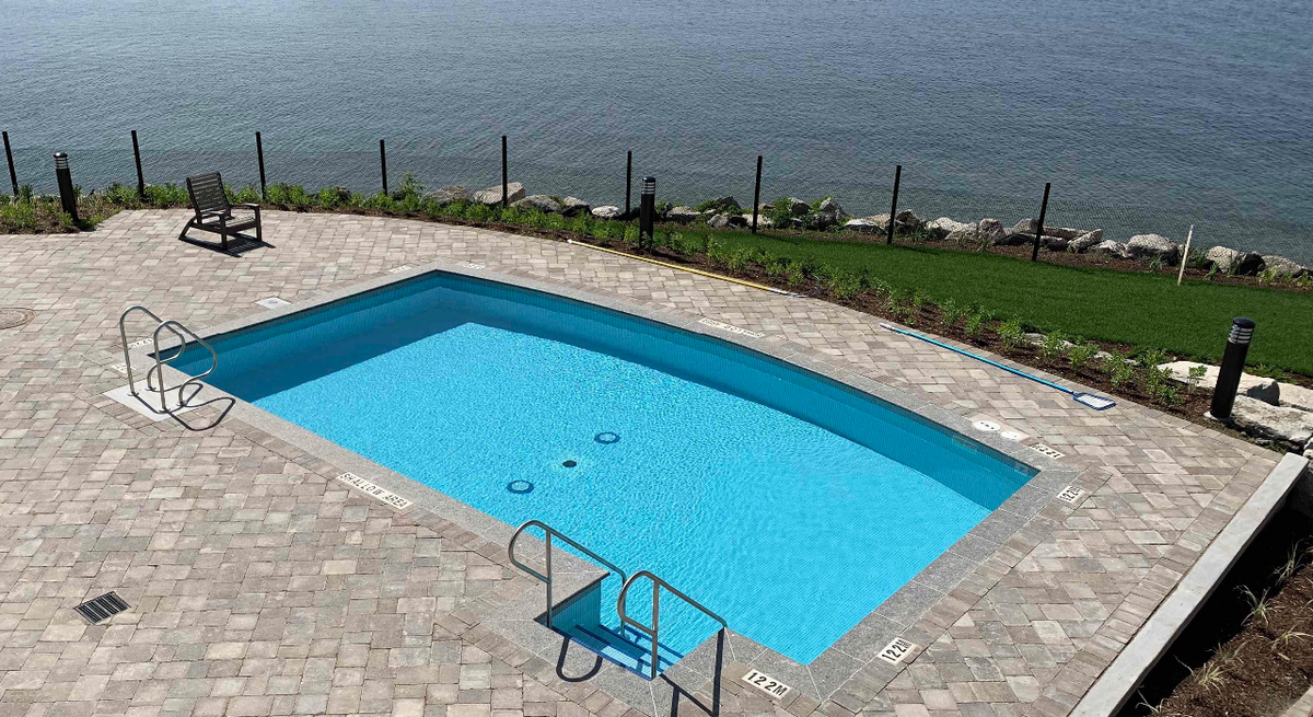 Outdoor leisure pool with lakeside views at the Orchard Point Harbour condos in Orillia, Ontario